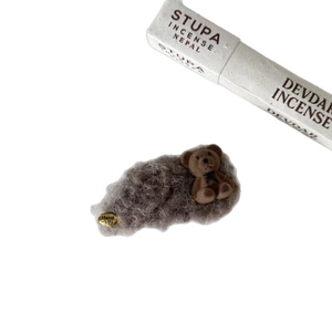 Brown fuzzy teddy bear hair clip with plush bow and handcrafted golden label detail