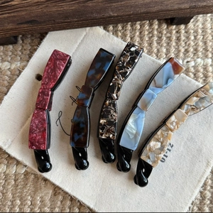 Set of five assorted acetate banana hair clips with retro marble and tortoiseshell patterns