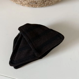 Detail showing the dense horizontal knit texture and smooth stitching on black hair accessory