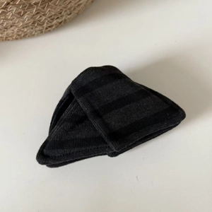 Detail of a black ribbed knit triangular padded insert with a vertical striped texture