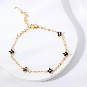 Elegant gold stainless steel bracelet featuring five black pavé zircon flower charms