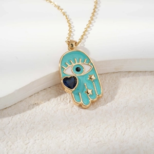 Detail of Hamsa pendant with turquoise enamel, evil eye, and heart on stone base