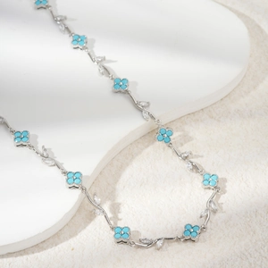Elegant silver necklace featuring sky blue clover petals and sparkling marquise zircons
