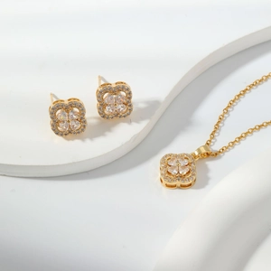 Golden clover jewelry set with sparkling zircon earrings and a matching pendant necklace