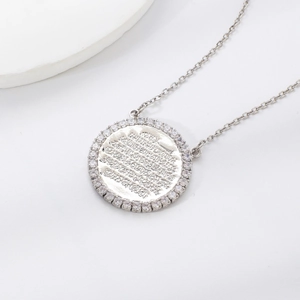 Silver disc pendant necklace with Arabic calligraphy and zircon stones on white background