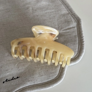 Elegant ink-brown marble acetate hair claw clip with a minimalist design on linen base