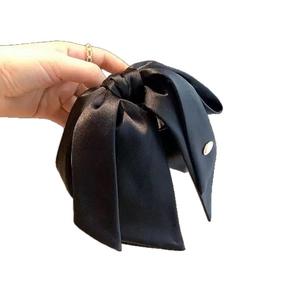 Elegant large black satin bow hair claw clip with silver button accent for women