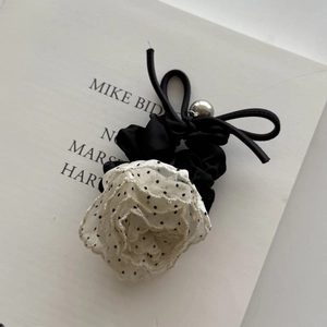 Elegant black satin scrunchie with polka dot chiffon flower and bow hair accessory