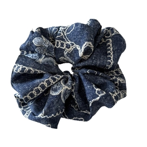 Floral denim scrunchie in deep blue fabric with white abstract floral prints for women