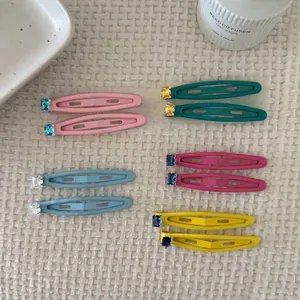 Detailed view of ten macaron-colored square crystal hair clips on waffle fabric