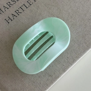 Detailed macro view of mint green marble flat hair claw clip made of premium ABS material