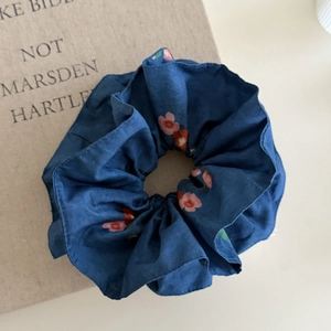 Dark blue scrunchie with pink floral prints and a stylish double-layered fabric design
