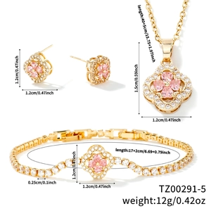 Detailed view of pink heart-shaped four-leaf clover jewelry set with gold plating