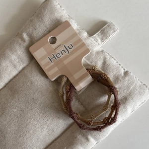 High-elasticity candy color braided hair ties in brown and beige on a card