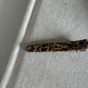 Detail of tortoise shell acetate hair clip with France Handmade gold engraving