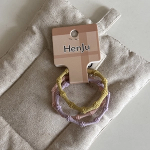 Detailed view of candy-colored elastic hair ties with textured bamboo design in a 3-pack
