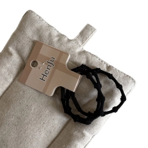 Set of two black high-elasticity bamboo-style hair ties with minimalist card packaging
