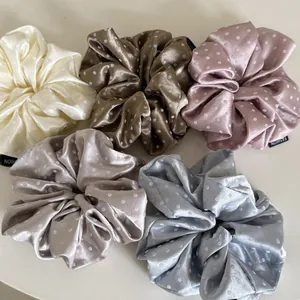 Detail view of 5-piece satin polka dot scrunchies set in assorted pastel colors
