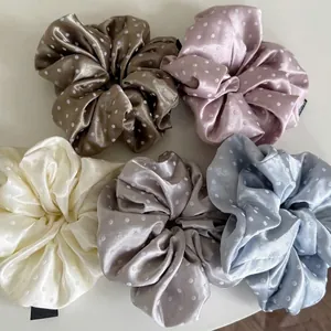 Five assorted polka dot satin scrunchies in coffee, pink, beige, gray, and blue colors