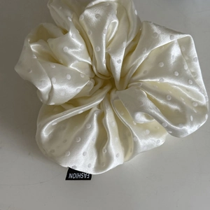 Elegant off-white satin polka dot hair scrunchie with fashion label for women's hairstyle