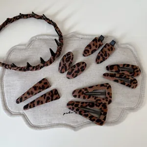 Detailed view of leopard print fabric headbands and hair clips with non-slip teeth