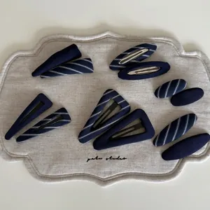 10-piece navy blue striped fabric-wrapped hair clip set with assorted geometric shapes