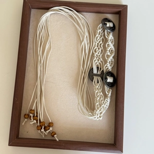 Detail of bohemian hand-woven waist chain with wooden beads and vintage metal buckles