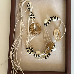 Detail of bohemian waist chain with wooden discs, beads, and long decorative tassels