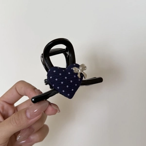 Navy polka dot heart hair claw clip with silver bow pendant on white background