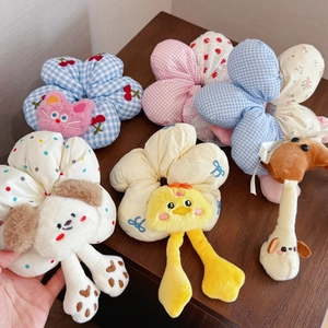 Five pieces of cute plush flower hair ties with 3D cartoon animal heads on a wooden surface