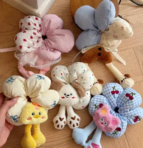 Detailed view of plush animal scrunchies with floral patterns and cute 3D cartoon embroidery