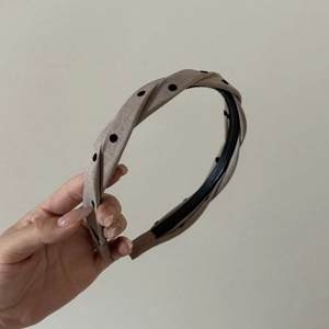 Braided polka dot headband in khaki fabric with stylish twisted knot design for women