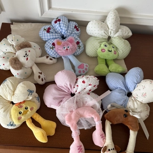 Detailed collection of plush animal scrunchies with floral patterns and cute cartoon designs