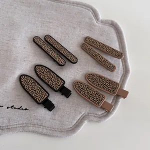 Set of eight leopard print hair clips featuring slim and rectangular barrette styles