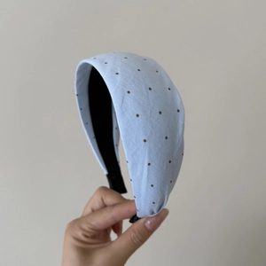Dettaglio del cerchietto azzurro a pois con fodera antiscivolo nera e morbido tessuto