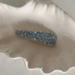 Elegant blue crystal hair clip for women with sparkling rhinestones in a shell tray