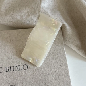 Minimalist pearl white acetate hair claw clip with marble texture for elegant hairstyles