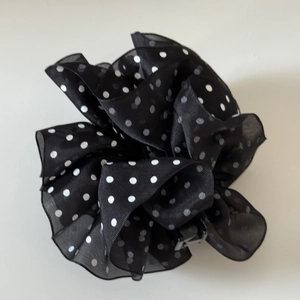 Close-up of French organza polka dot hair clip featuring layered pleats and flower shape