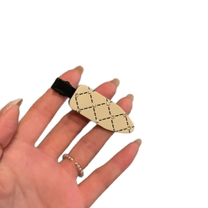 Beige quilted hair clip with rhinestones and duckbill clasp for elegant hairstyling
