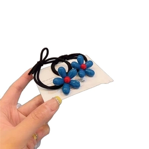 Pair of blue floral hair elastics with high elasticity for ponytails on white card