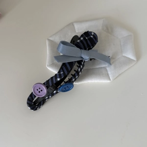 Blue ribbon bow hair clip with dark plaid fabric pattern for elegant hairstyles