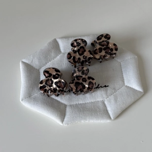 Set of four mini brown leopard print hair claws for stylish women's half-up hairstyles