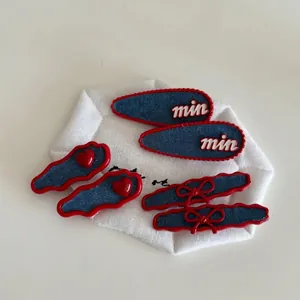 Red and blue hair clip set with denim bows, heart charms and letter embroidery