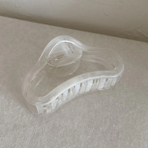 Detail view of marble patterned acrylic hair claw clip with strong metal spring