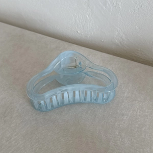 Detailed view of light blue translucent jelly hair claw clip with geometric hollow design