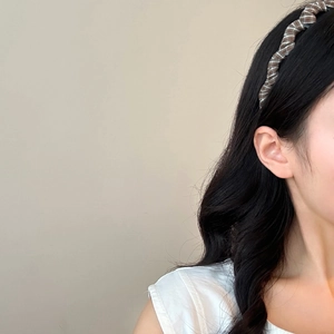 Vintage brown plaid twisted headband with fabric texture shown on model in a side view