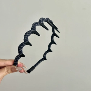 Close-up of vintage plaid fabric headband with black plastic inner non-slip teeth