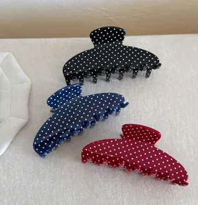 Detailed set of three large polka dot hair claws in black, navy, and wine red colors