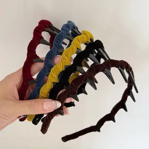 Detail of velvet textured headbands in multiple colors with internal non-slip teeth combs