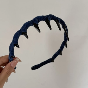 Detail of dark blue velvet headband showing anti-slip inner teeth for secure hair grip